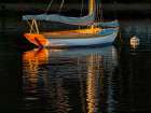 USA, Massachusetts, Cape Cod, Falmouth. Vintage sailboat moored in Quissett Harbor at sunset Art Print